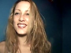 Smiling blonde chick showing her big decolletage at a party