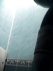 A sexy young girl with tight pussy is pissing in the public toilet