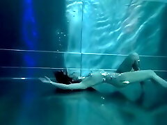 Bond Woman, underwater stunts, nerd girl, high heels glamor and underwater swimming retro style 