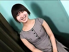 Enticing Asian shemale with a lovely smile sensually drops he