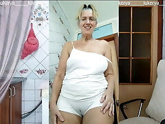 Lukerya in the kitchen in wet milky panties, bottom view