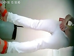 Asian woman in white pants peeing