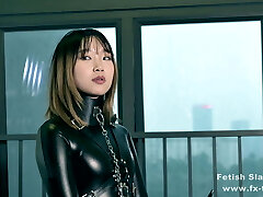 Restrain Bondage leather catsuit girl on single gloves