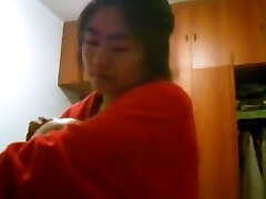 Asian girl with big breasts changes clothes in her bedroom