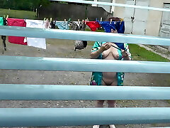 Naked in public. Neighbor saw pregnant neighbor in window who was drying clothes in yard sans bra and panties. Nudist