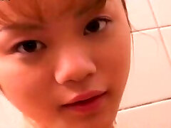 Adorable petite Japanese girlie takes shower flashing her nice ass and titties