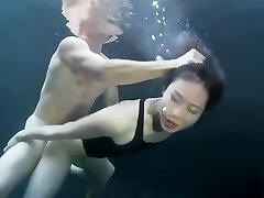 swimsuit female sex with a guy underwater