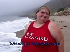 Gigantic lifeguard bitches eat food on the beach
