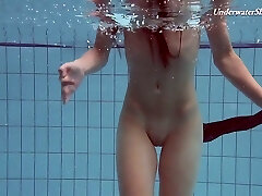 Pretty swimming honey Liza Rachinska shows striptease under the water