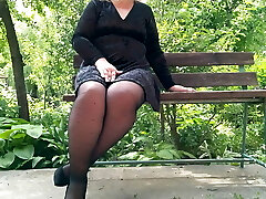 Kinky milf in tights pissing in the park on a bench – rear view