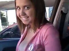 Happy young babe in the car shows her gorgeous tits