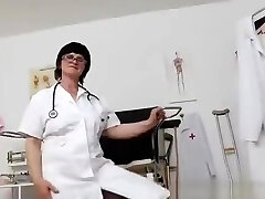 Black-haired practical nurse examining her vagina