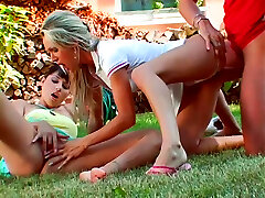 Two amazing gals get busy with sucking a stiff fat cock right in the yard