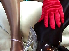 Sensual teasing close up legs and feet in Shiny glossy stockings and high stilettos.