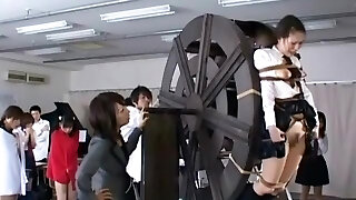 japanese schoolgirls punished on waterwheel
