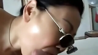 Asian girl with sunglasses fellates cock, while getting fingered.