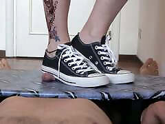 Mistress Elle in converse stomp her slaves cock on trampling table