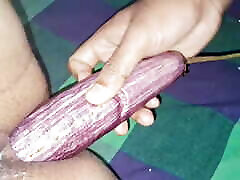 Asian mom helpping girl took down a brinjal