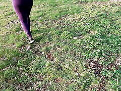 Barefoot on the meadow treats naked tits