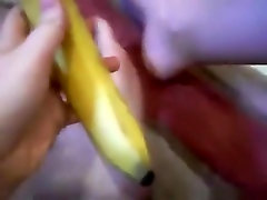 Girl masturbates her shaved pussy closeup with a banana