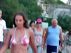 Beach voyeur spying on a woman walking around in her tight bikini