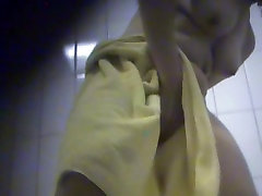 Mature woman putting her thongs on after a hot shower