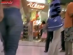 Sexy girl walking around a mall with a voyeur cam following