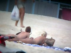 Beach spy jadter girl captures two friends sunbathing topless