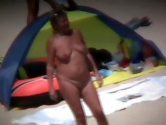 Chubby mature women filmed on a woman wetting beach