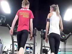 Athletic asses in latex catsuit and hood on the treadmill