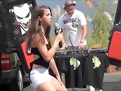 Teen Latina dancing and singing in a parking lot