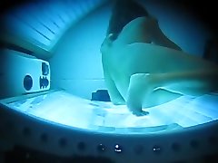 PEEPHOLE CAPTURES WIFE MASTURBATING IN TANNING BED