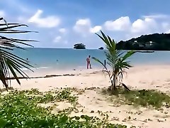 Chic malwari com with a blonde on a sandy beach