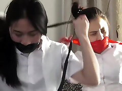 Chinese secretaries in white shirts are thoroughly gagged