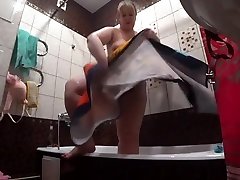 Lesbian has installed a hidden camera in the bathroom at his girlfriend. Peeping behind a tied machine slave with a big ass in the shower. Voyeur.