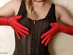 Chic Redhead Dances in Black Leather Leggings and Red Gloves