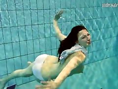 Brunette big tits teen Andrea swimming in the pool