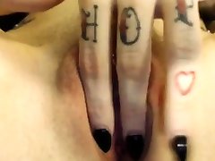 girl with tattoos and black nails plays stepp kick pussy