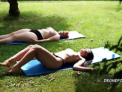 Two twing gay sex girls sunbathing in the city park