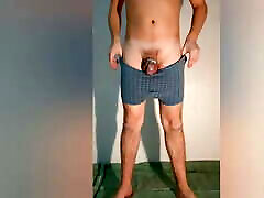 The guy shows how the chastity belt looks in boxer shorts