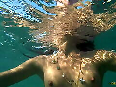 Nude hedei romanova swims on a public beach in Russia.