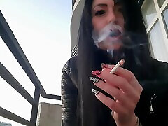 Smoking lingerie showing from sexy Dominatrix Nika. Pretty woman blows cigarette smoke in your face