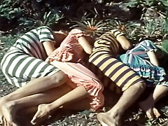 Blonde hottie gets fucked from behind in a forest in retro vid