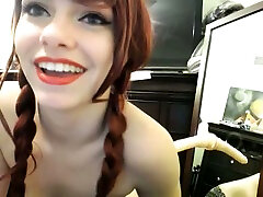 Comely redhead with pigtails sucks her suction cup dildo on cam