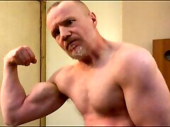 Muscular Daddy bodybuilder flexing muscles in sexy lun story vest then strips naked and jerks off his big cock!