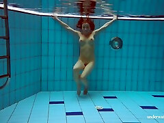 In The Indoor Pool, A Stunning Girl Swims