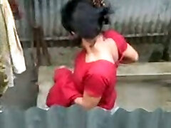 Mature ugly Indian dark haired takes a shower outdoors and displays tits