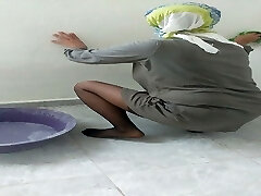 Hijab damsel cleaning kitchen