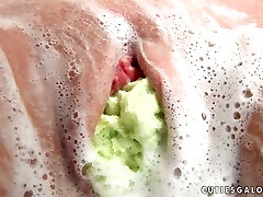 Cute girl Penny stuffs her labia with some soapy fabrics