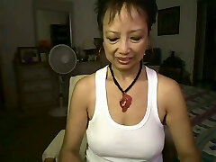 Horn made Asian grandma pokes her brown spread pussy with dildo